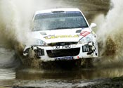 Rally car driving through water, from the original specialist-filming archive